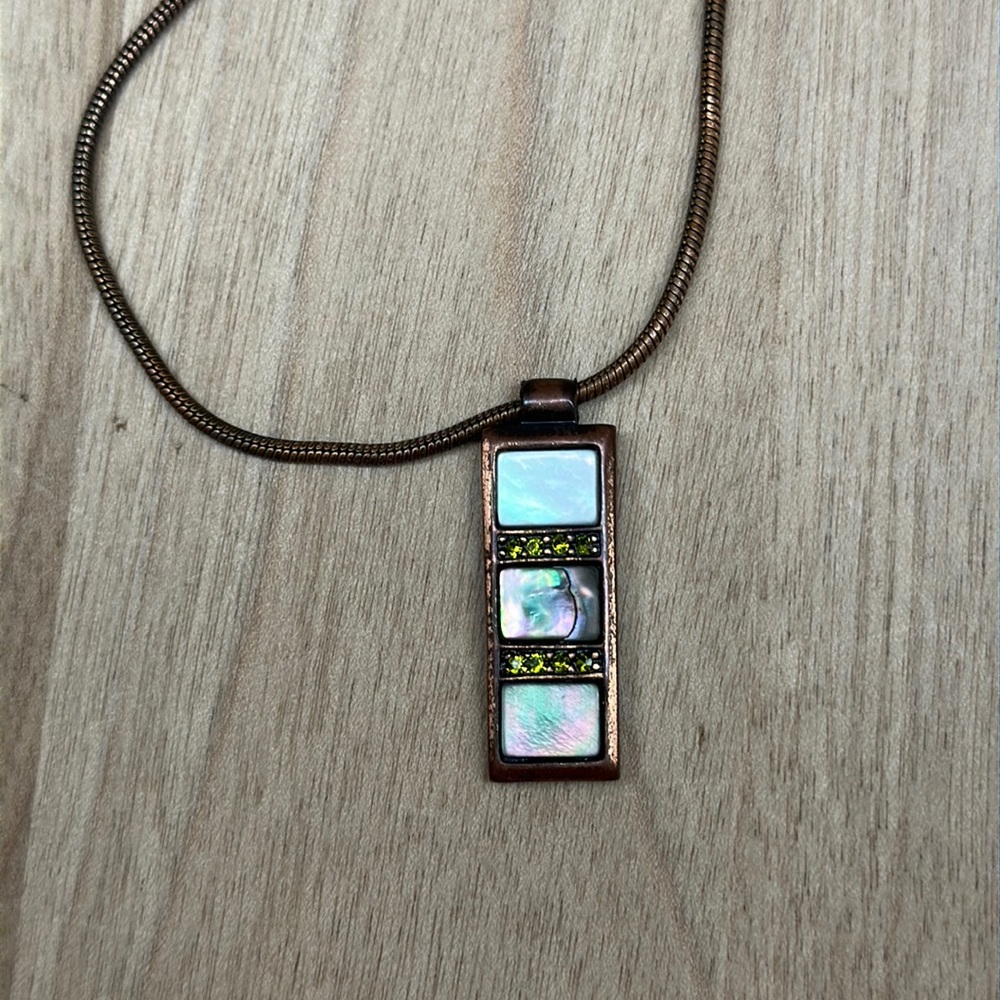 Bronze colored necklace with green stones and pearly square stones.